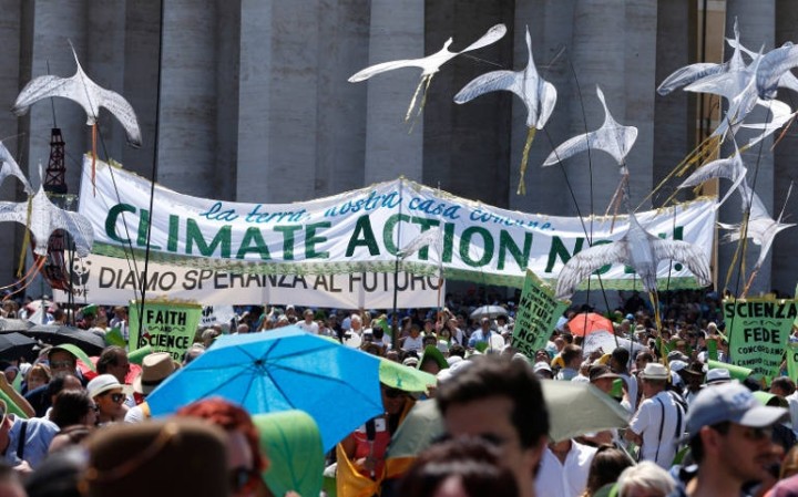A banner calling attention to climate change is seen in St. Peter's Square at the Vatican June 28. Some 1,500 people marched to the Vatican in support of Pope Francis' recent encyclical on the environment. (CNS photo/Paul Haring)